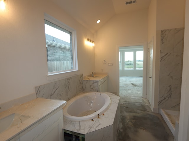 8311 Oceanmist Cove Dr, Cypress, TX 77433 - bathroom with lofted ceiling, a garden tub, vanity, and a marble finish shower