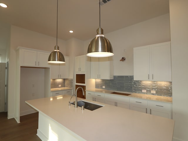 8311 Oceanmist Cove Dr, Cypress, TX 77433 - kitchen with a sink, a center island with sink, decorative backsplash, white cabinets, and recessed lighting
