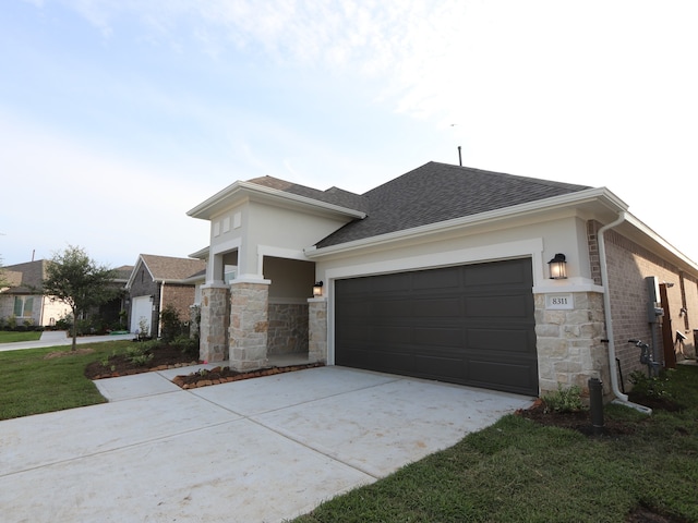8311 Oceanmist Cove Dr, Cypress, TX 77433 - view of front of property with concrete driveway, roof with shingles, an attached garage, stone siding, and stucco siding