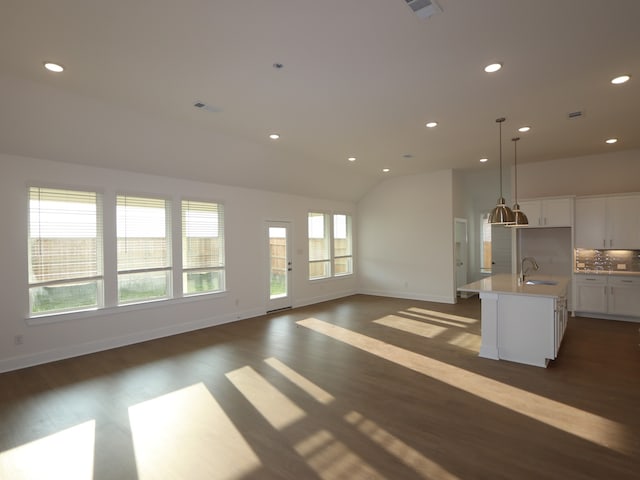 8311 Oceanmist Cove Dr, Cypress, TX 77433 - unfurnished living room with a sink, dark wood-type flooring, recessed lighting, baseboards, and lofted ceiling