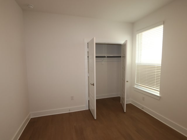 8311 Oceanmist Cove Dr, Cypress, TX 77433 - unfurnished bedroom featuring wood finished floors, baseboards, and a closet