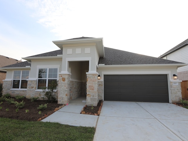 8311 Oceanmist Cove Dr, Cypress, TX 77433 - prairie-style home featuring an attached garage, stone siding, driveway, stucco siding, and a shingled roof