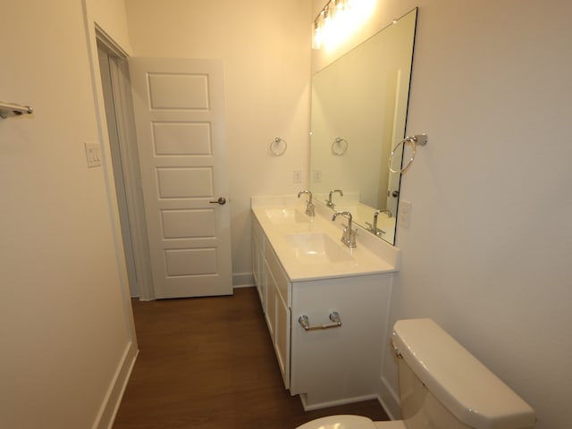 8311 Oceanmist Cove Dr, Cypress, TX 77433 - bathroom featuring wood finished floors, toilet, double vanity, and baseboards