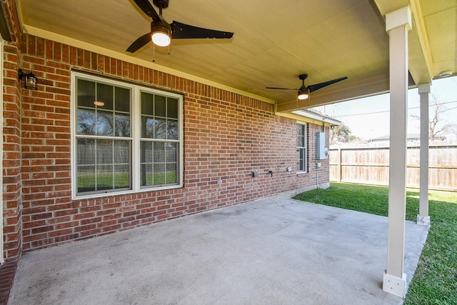 view of patio with fence and a ceiling fan