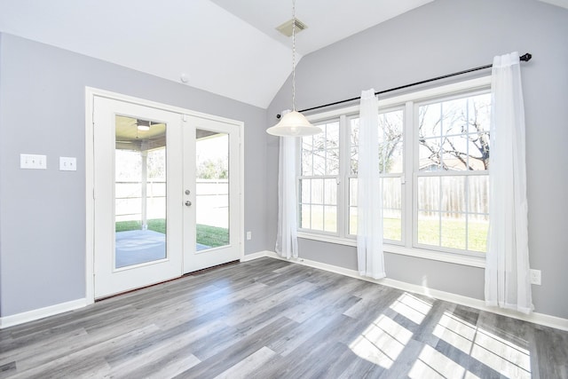 doorway featuring lofted ceiling, wood finished floors, visible vents, baseboards, and french doors