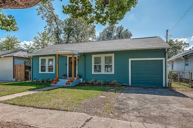 ranch-style house featuring a garage, driveway, a front lawn, and fence