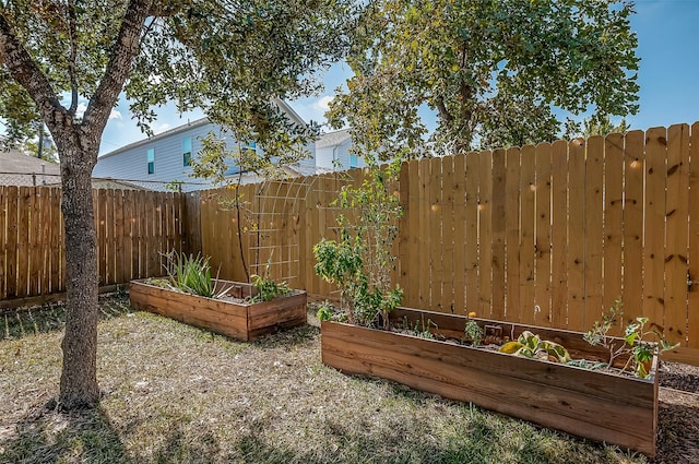 view of yard featuring a vegetable garden and fence