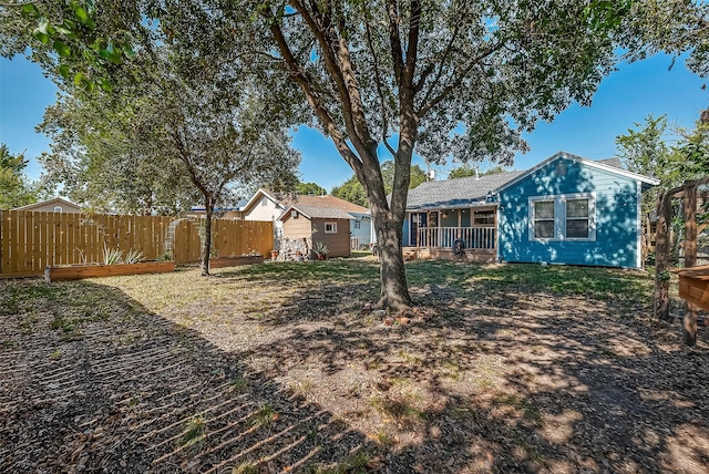 view of yard with an outbuilding, a storage shed, and fence