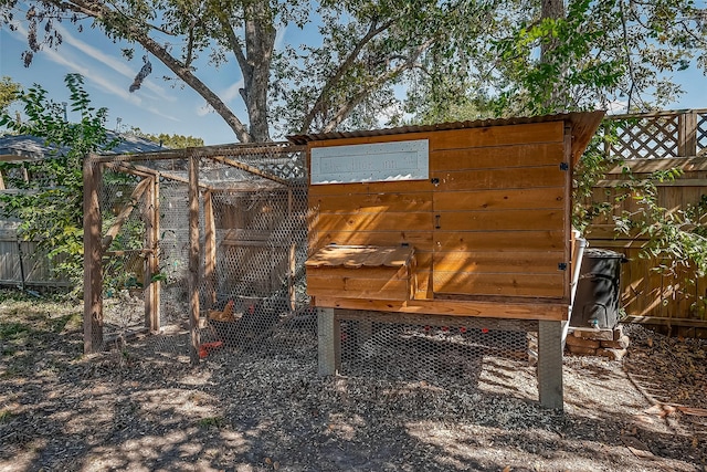 view of poultry coop featuring fence