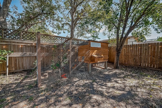 view of yard with fence, exterior structure, and an outbuilding