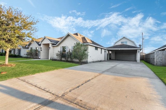 view of front facade featuring driveway, an attached garage, fence, a front yard, and brick siding