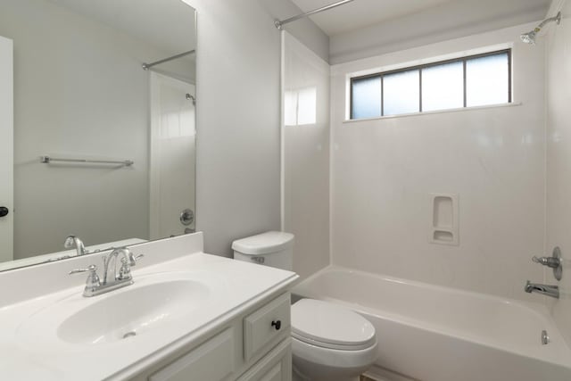 bathroom featuring toilet, washtub / shower combination, and vanity