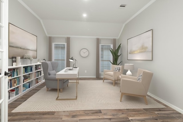 sitting room featuring lofted ceiling, crown molding, baseboards, and wood finished floors