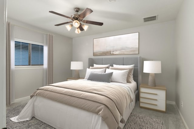 carpeted bedroom featuring ceiling fan, visible vents, and baseboards