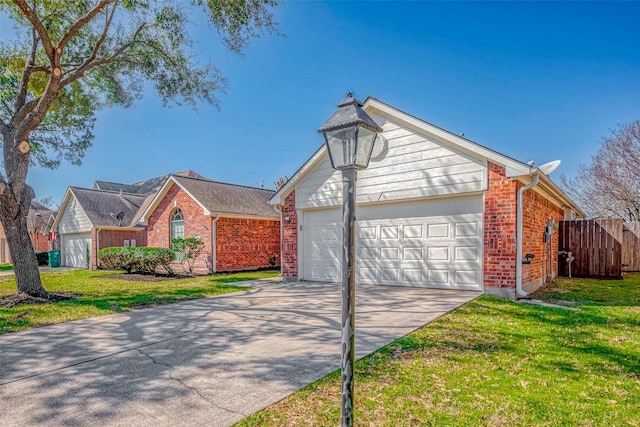 view of front of property featuring concrete driveway, brick siding, a front yard, and fence