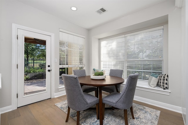 dining room with visible vents, baseboards, and wood finished floors