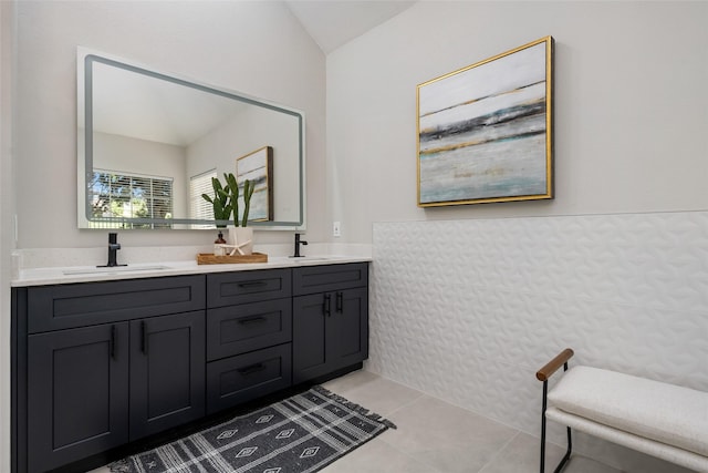 full bathroom featuring double vanity, a sink, and tile patterned floors