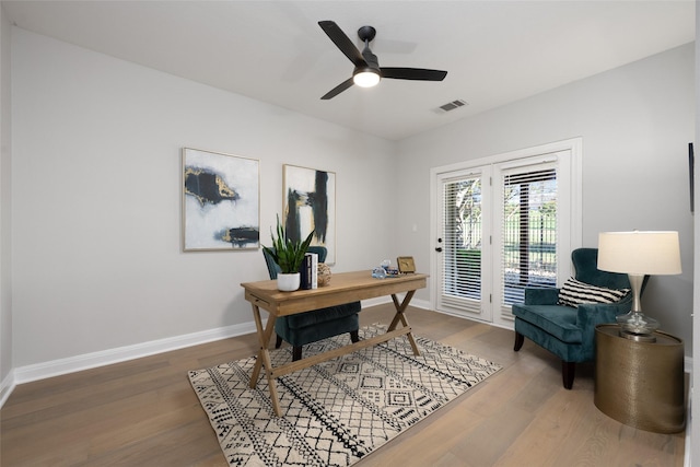 office with baseboards, visible vents, ceiling fan, and wood finished floors