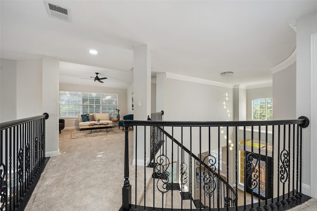 corridor featuring plenty of natural light, carpet flooring, an upstairs landing, and visible vents