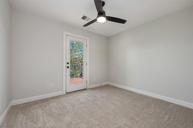 empty room with a ceiling fan, light carpet, visible vents, and baseboards