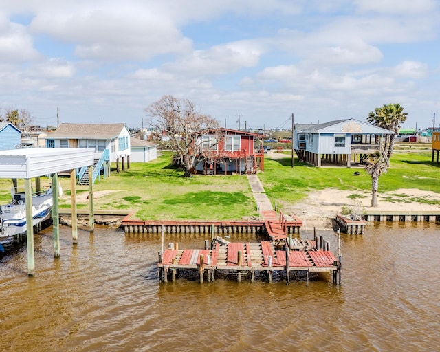 view of dock featuring a yard, stairway, a water view, and boat lift