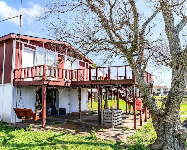 back of property with stairway and a wooden deck