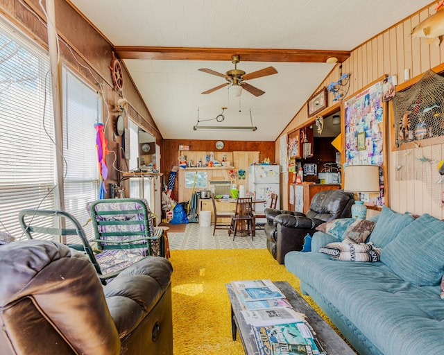 living room featuring lofted ceiling with beams, ceiling fan, and wooden walls