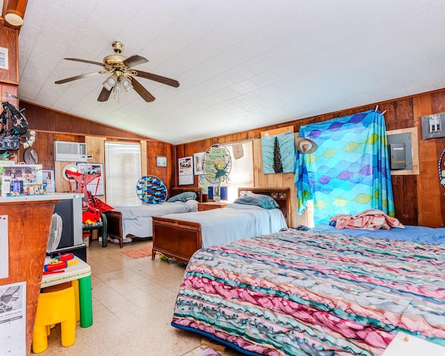 bedroom featuring light floors, ceiling fan, wooden walls, and vaulted ceiling