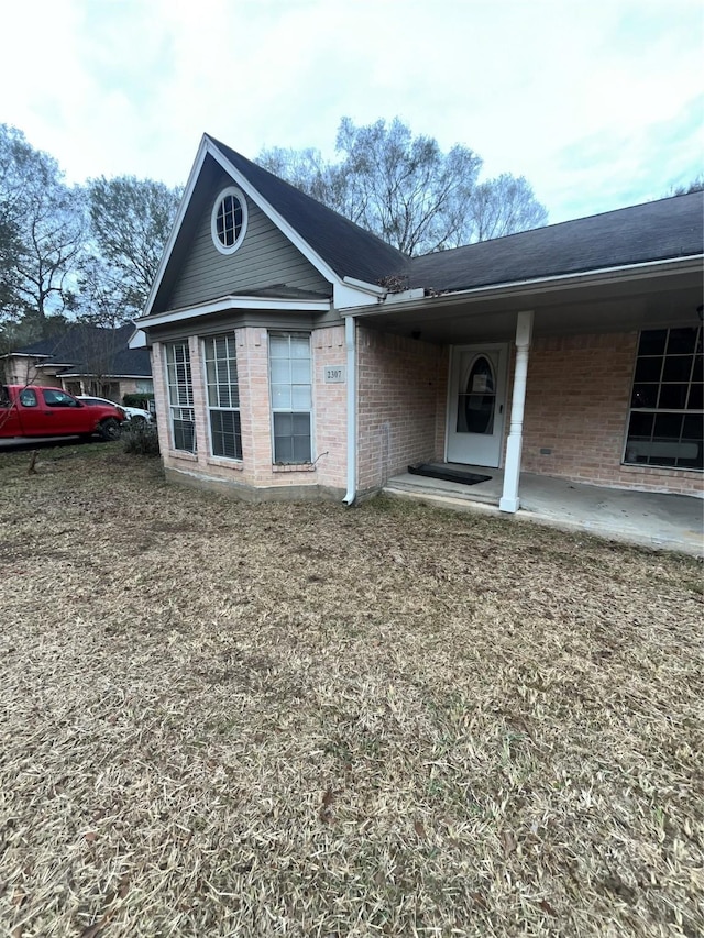 view of front of property featuring brick siding