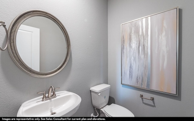 14127 Gingko Ct, Crosby, TX 77532 - bathroom with a sink, toilet, and a textured wall