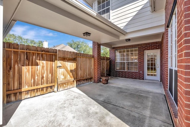 view of patio with a gate and fence