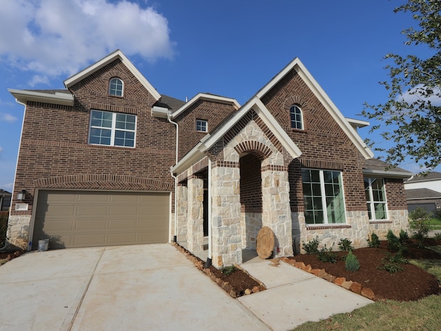 8502 Pier Cove Dr, Cypress, TX 77433 - traditional-style house featuring stone siding, an attached garage, driveway, and brick siding