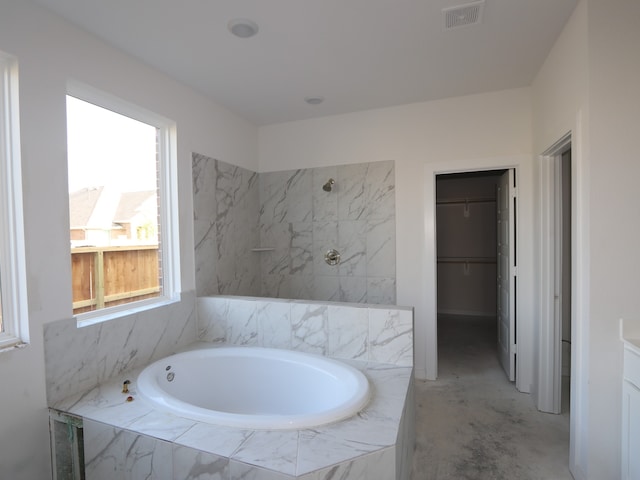 8502 Pier Cove Dr, Cypress, TX 77433 - bathroom with a spacious closet, a garden tub, a shower, and unfinished concrete flooring