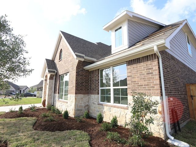 8502 Pier Cove Dr, Cypress, TX 77433 - view of side of property with stone siding, brick siding, and roof with shingles