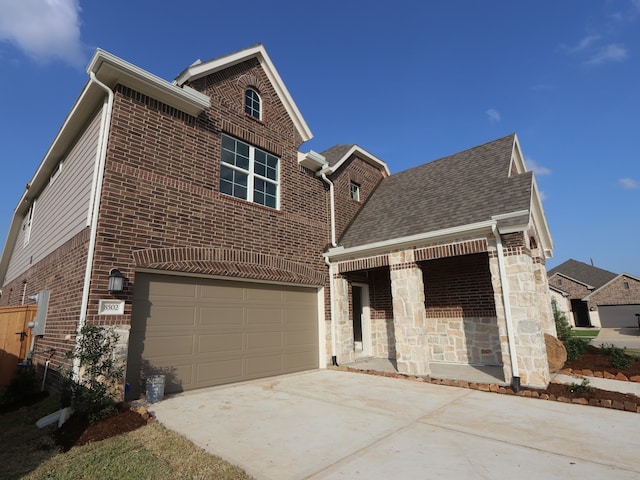 8502 Pier Cove Dr, Cypress, TX 77433 - view of front facade with concrete driveway, brick siding, a garage, and roof with shingles