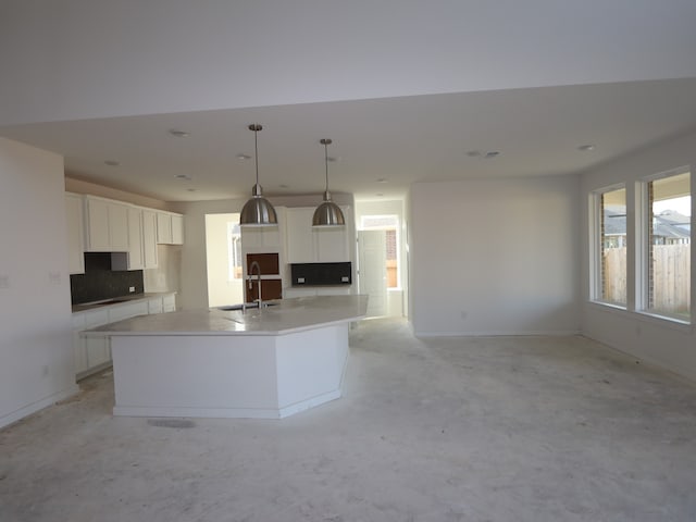 8502 Pier Cove Dr, Cypress, TX 77433 - kitchen featuring a sink, a large island with sink, white cabinetry, tasteful backsplash, and recessed lighting