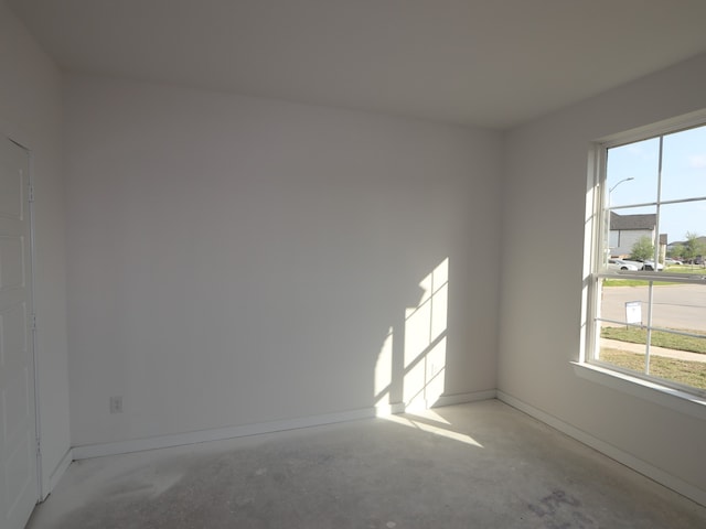8502 Pier Cove Dr, Cypress, TX 77433 - empty room with unfinished concrete flooring and baseboards