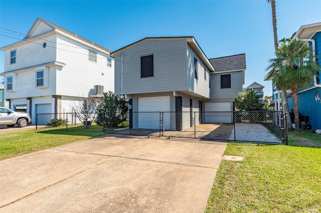 view of front of house with concrete driveway, fence, a garage, a residential view, and a front lawn