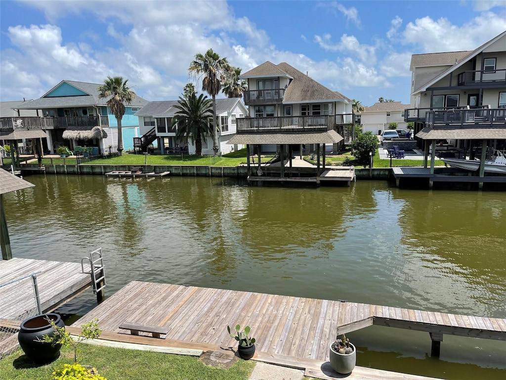 view of dock with a water view and a residential view