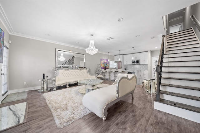 living room featuring ornamental molding, stairway, wood finished floors, and baseboards