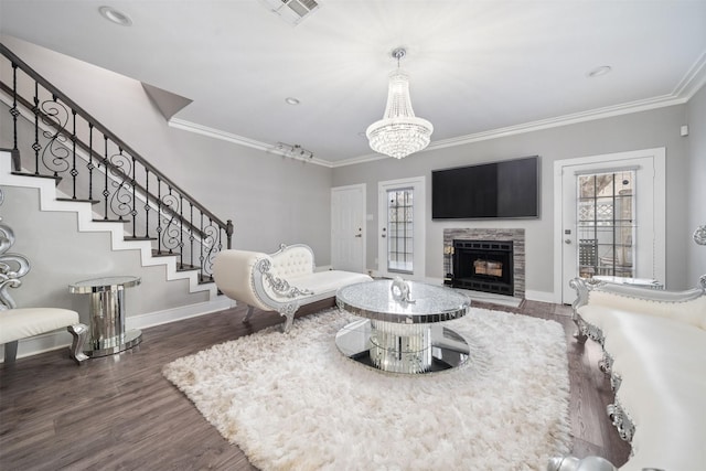 living room featuring a wealth of natural light, ornamental molding, stairway, and visible vents