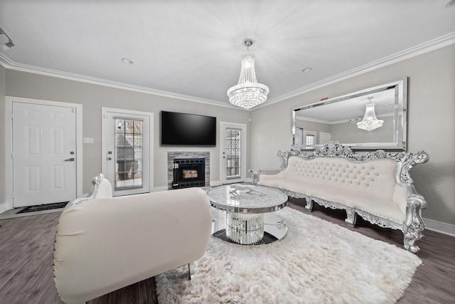 living area with baseboards, dark wood-style flooring, a fireplace, and crown molding