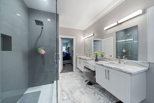 full bathroom featuring double vanity, a stall shower, ornamental molding, marble finish floor, and a sink