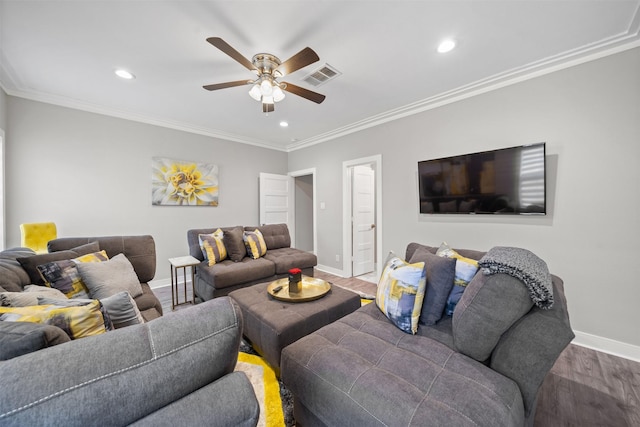 living room with baseboards, crown molding, visible vents, and wood finished floors