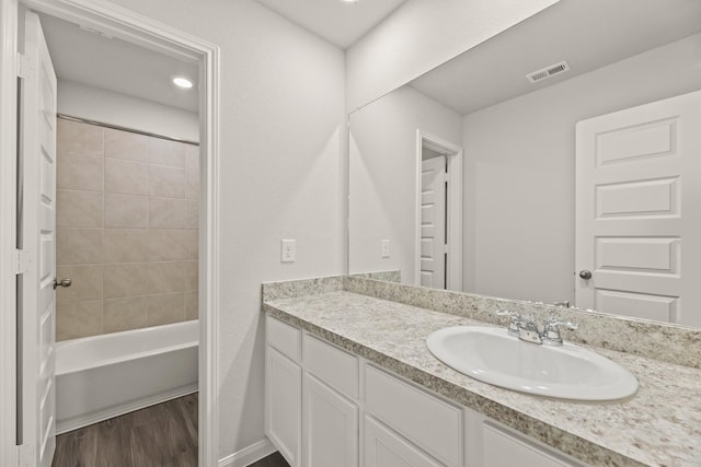 16539 Willow Forest Dr, Conroe, TX 77302 - full bath with vanity, wood finished floors, and shower / bathtub combination