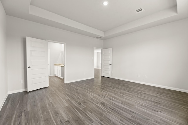 16539 Willow Forest Dr, Conroe, TX 77302 - unfurnished bedroom with a raised ceiling, dark wood-style flooring, baseboards, and recessed lighting
