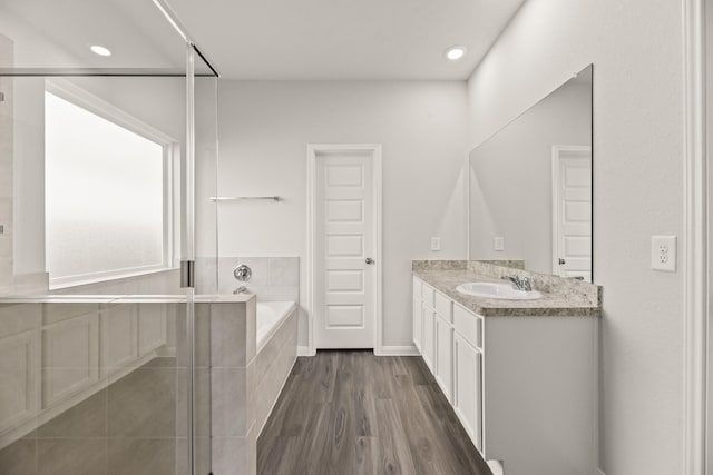 16539 Willow Forest Dr, Conroe, TX 77302 - bathroom featuring vanity, a garden tub, a shower stall, wood finished floors, and recessed lighting