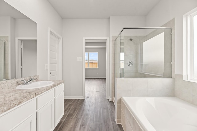 16539 Willow Forest Dr, Conroe, TX 77302 - full bathroom featuring a stall shower, vanity, a garden tub, and wood finished floors
