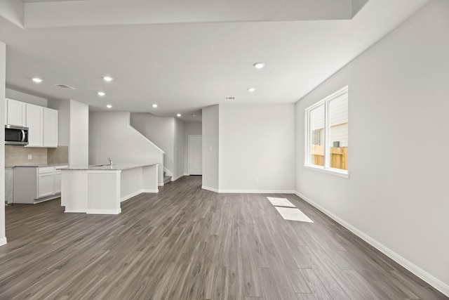 16539 Willow Forest Dr, Conroe, TX 77302 - unfurnished living room with wood finished floors, recessed lighting, and baseboards