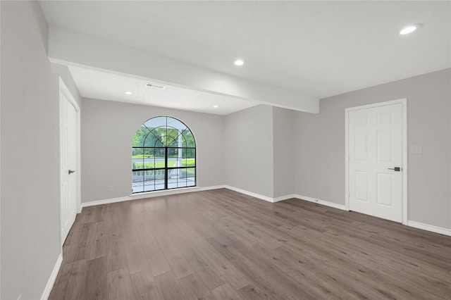 empty room featuring recessed lighting, visible vents, baseboards, and wood finished floors